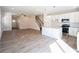 Inviting living space showcasing open layout, hardwood floors, and a modern kitchen with white cabinets at 620 Smith St # B, Mooresville, NC 28115