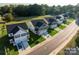 New homes line a street, each with a driveway, small yard, and attractive facade at 620 Smith St # B, Mooresville, NC 28115