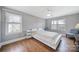 Bright bedroom features two windows, hardwood floors, and ceiling fan at 726 Amberly Xing, Fort Mill, SC 29708