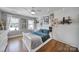 Well-lit bedroom with hardwood floors, three windows, and decorative wall decor at 726 Amberly Xing, Fort Mill, SC 29708