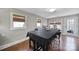 Bright dining room with large windows, hardwood floors, and black table with seating for eight at 726 Amberly Xing, Fort Mill, SC 29708