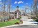 Stately brick home features a manicured lawn, mature trees, and an attached two-car garage at 726 Amberly Xing, Fort Mill, SC 29708