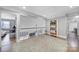 Hallway features hardwood flooring, a plush rug, and a view to the staircase and bedroom at 726 Amberly Xing, Fort Mill, SC 29708