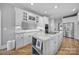 Bright kitchen features a center island with granite countertops and stainless steel appliances at 726 Amberly Xing, Fort Mill, SC 29708