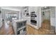 Open kitchen with hardwood floors, gray island with stone countertop and stainless steel appliances at 726 Amberly Xing, Fort Mill, SC 29708