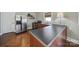 Well-lit kitchenette with stainless steel appliances, dark countertops, and hardwood floors at 726 Amberly Xing, Fort Mill, SC 29708