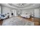 Spacious primary bedroom with hardwood floors, seating area, and ensuite bathroom at 726 Amberly Xing, Fort Mill, SC 29708