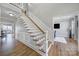 Elegant staircase featuring white railings, wood treads, and detailed wainscoting at 726 Amberly Xing, Fort Mill, SC 29708