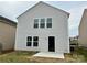 This backyard features a concrete patio, a gray exterior, and views of the surrounding neighborhood at 7306 Fox Point Dr, Charlotte, NC 28269