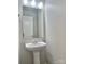 Powder room featuring a pedestal sink, a decorative mirror, and modern fixtures at 7306 Fox Point Dr, Charlotte, NC 28269