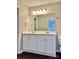 This bathroom has a double sink vanity with a large mirror and overhead lights at 7306 Fox Point Dr, Charlotte, NC 28269