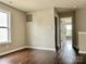 Neutral bedroom with a window and wood-look flooring at 7306 Fox Point Dr, Charlotte, NC 28269