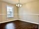 Dining area with hardwood floors, a chandelier, a large window that lets in natural light at 7306 Fox Point Dr, Charlotte, NC 28269