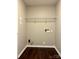 An empty laundry room includes plumbing and electrical hookups for a washer and dryer at 7306 Fox Point Dr, Charlotte, NC 28269