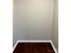A small empty room with neutral walls and brown wood-look flooring at 7306 Fox Point Dr, Charlotte, NC 28269