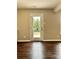 Neutral room with a glass door leading to an outdoor view of green trees and grass at 7306 Fox Point Dr, Charlotte, NC 28269