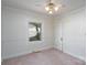 A cozy bedroom with pink carpet, a ceiling fan, and natural light from a window at 732 Ideal Se Dr, Concord, NC 28025