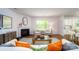 Bright living room featuring a cozy fireplace and an open floor plan to the kitchen at 7724 Woolsey Dr, Gastonia, NC 28056