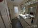 Spacious bathroom features a large vanity with storage, neutral colors and plenty of light at 8015 Sullivan Dr # 3 And 2, Charlotte, NC 28215