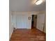 A bright bedroom with closet doors and doorway leading to another room at 8015 Sullivan Dr # 3 And 2, Charlotte, NC 28215