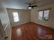A well-lit bedroom featuring hardwood floors, ceiling fan and natural light at 8015 Sullivan Dr # 3 And 2, Charlotte, NC 28215