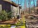 Home exterior featuring a stone pathway and lush green moss at 8015 Sullivan Dr # 3 And 2, Charlotte, NC 28215