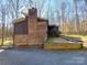 Home exterior with brick and siding, set against a wooded backdrop at 8015 Sullivan Dr # 3 And 2, Charlotte, NC 28215
