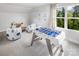 Bright game room with a foosball table, cozy beanbag chairs, and a large window with a scenic view at 9416 Munsing Dr # 151, Charlotte, NC 28269