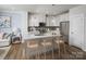 Modern kitchen with stainless steel appliances, kitchen island and wood floors at 9416 Munsing Dr # 151, Charlotte, NC 28269