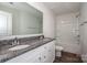 Bright bathroom with a granite countertop, double sinks, and a shower-tub combo at 955 General Hoke Dr, Lincolnton, NC 28092