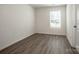 Bright bedroom with wood-look floors and a large window at 955 General Hoke Dr, Lincolnton, NC 28092