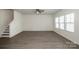 Large living room space with wood-look floors and a staircase to the second floor at 955 General Hoke Dr, Lincolnton, NC 28092