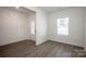Spacious living room with wood-look floors, a large window, and an entry door at 955 General Hoke Dr, Lincolnton, NC 28092