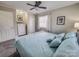 Comfortable primary bedroom offers closet space and a soothing paint palette at 1007 Little John Trl, Kannapolis, NC 28081