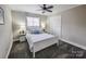 Cozy bedroom features a white bed frame, soft carpet, and a ceiling fan at 1007 Little John Trl, Kannapolis, NC 28081