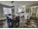 Eat-in dining space off the kitchen features modern light fixture and neutral decor at 1007 Little John Trl, Kannapolis, NC 28081