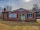 Charming brick home featuring a cozy front porch and well-maintained landscaping at 1007 Little John Trl, Kannapolis, NC 28081