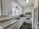 Well-lit kitchen featuring stainless steel appliances, granite countertops, and ample cabinet space at 1007 Little John Trl, Kannapolis, NC 28081