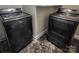 Laundry room showcases a modern washer and dryer set on a tiled floor at 1007 Little John Trl, Kannapolis, NC 28081