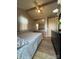 Comfortable bedroom featuring laminate floors, ceiling fan, ample closet space and pleasant natural light at 109 Hummingbird Cir, New London, NC 28127