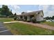 Charming community clubhouse with a brick walkway and well-maintained landscaping at 109 Hummingbird Cir, New London, NC 28127