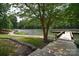 Scenic waterfront with a wooden boardwalk leading to a private dock on a calm lake at 109 Hummingbird Cir, New London, NC 28127