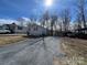 Exterior of the house, featuring a spacious driveway, well-kept surroundings and a shed for additional storage at 109 Hummingbird Cir, New London, NC 28127