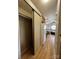 Hallway view connecting closet, kitchen, and living area with modern accents and functional design at 109 Hummingbird Cir, New London, NC 28127