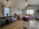 Bright living room with stylish furnishings, natural light, vaulted ceiling, and an inviting atmosphere at 109 Hummingbird Cir, New London, NC 28127