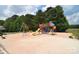 Colorful community playground with slides, swings, and climbing structures on a sand base at 109 Hummingbird Cir, New London, NC 28127