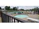 Community swimming pool and hot tub area with plenty of lounge chairs and picnic tables under umbrellas at 109 Hummingbird Cir, New London, NC 28127