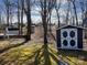 A backyard shed providing extra storage space, set amongst the trees in a lovely setting at 109 Hummingbird Cir, New London, NC 28127