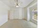 Spacious bedroom with large windows, a ceiling fan, and generous closet space at 11027 Brief Rd, Charlotte, NC 28227