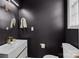Modern powder room features a sleek vanity, round mirror, and stylish fixtures at 11406 Potters Row, Cornelius, NC 28031